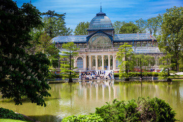 Fototapeta na wymiar View of the beautiful Palacio de Cristal a conservatory located in El Retiro Park built in 1887 in Madrid