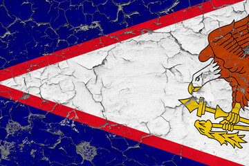 American Samoa flag close up grungy, damaged and weathered on wall peeling off paint to see inside...