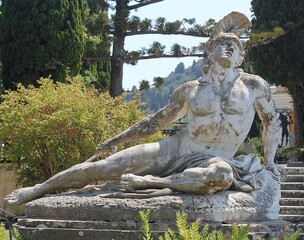 Fototapeta na wymiar Statue of Achilleas with spear in heel in the park. Achilleas heel phrase.