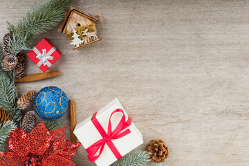 Christmas holidays composition with decorations, presents, tree balls, pine cones and plants on white wooden board background with copy space for your text. Flat lay, top view