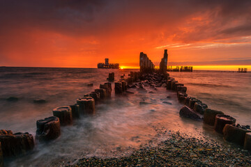 Dramatic sunrise over the sea. Famous place on the Baltic coast, beach near the old torpedo plant...