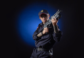 Fototapeta premium the guy in the police uniform with a gun is a Russian policeman. English translation of 