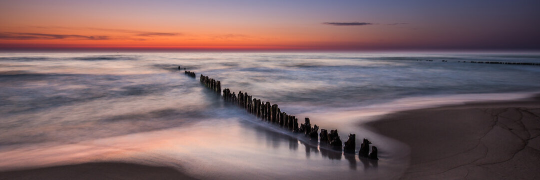 Waiting for sunrise on the beach in Chalupy. A quiet and peaceful place ideal for rest and relaxation. Famous naturist beach. Widescreen(panoramic) banner of vacations landscape.