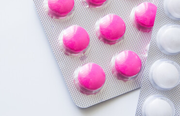Pink ibuprofen painkillers in grey packaging. Medical use for aches, pain and inflammation.