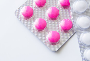 Pink ibuprofen painkillers in grey packaging. Medical use for aches, pain and inflammation.