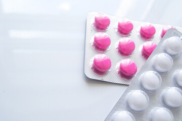 Pink ibuprofen painkillers in grey packaging. Medical use for aches, pain and inflammation.