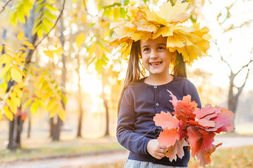 Autumn season leisure. Atmosphere of autumn. Adorable smiling schoolgirl autumn foliage background. Good mood. Happy child. Welcome october. United with nature. Little child walk in autumn park.