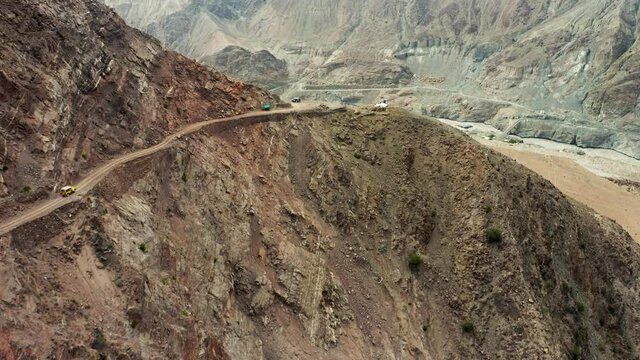 Two jeepneys passing by on mountain road to Fairy Meadows, Nanga Parbat, drone
