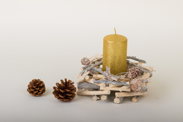Christmas holidays composition with decorations, golden candles and pine cones on white background with copy space for your text. 