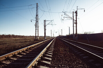 Fototapeta na wymiar Railway tracks and electric lines in the industrial zone.