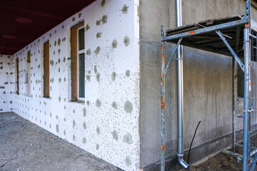 the facade of the house, which is covered with thermal insulation boards