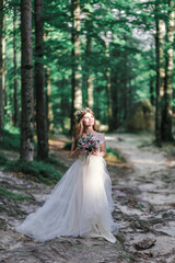 Fototapeta na wymiar Wedding fashion bride with bouquet in hands