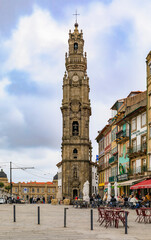 Fototapeta na wymiar Torre dos Clerigos church bell tower and outdoor cafes in traditional houses with ornate azulejo tiles in Porto Portugal