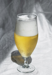 Glass with cold refreshing beer on a white background, in the art style. The concept of relaxation, bars and parties