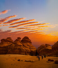 Tourists at Mada'in Saleh archaeological sites near Al Ula at Sunset, Saudi Arabia