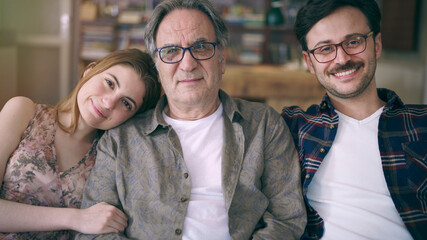 Young son and daughter embracing his father with love