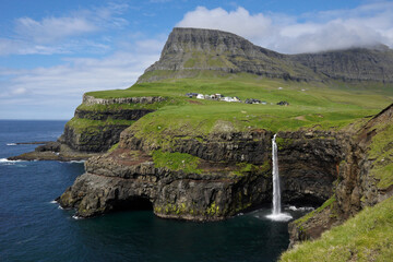 Village of Gasaladur and waterfall into the sea, Vagar Island, Faroe Islands