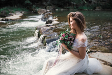 Fototapeta na wymiar Bride holds a wedding bouquet, wedding dress, wedding details