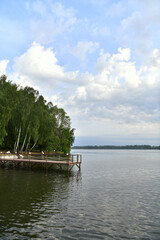 natural landscape with river forest and fantastic clouds in the sky