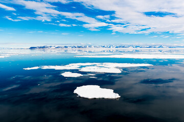 Cloudy sky and Ice pieces on the water in Arctic
