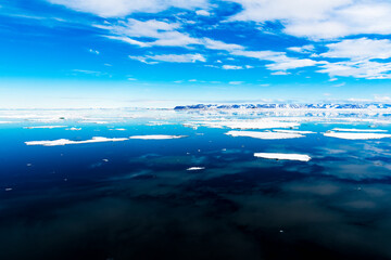Cloudy sky and Ice pieces on the water in Arctic