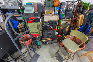 Overflowing storage mess in typical suburban residential garage.