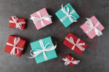 Multicolored gift boxes on dark stone background