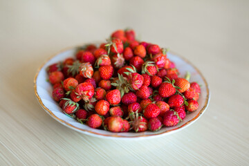 plate of ripe red strawberries