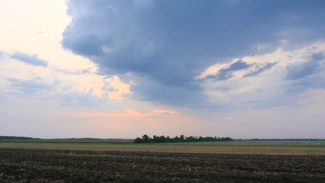 Driving Along Cultivated Farm Field. Sky Horizon over Rural Landscape