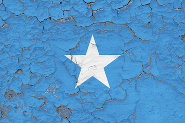 Somalia flag close up grungy, damaged and weathered on wall peeling off paint to see inside surface. Vintage concept.