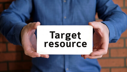 Target resource - a man in a blue shirt holds a sign with the text in one hand