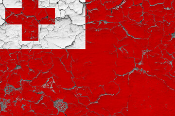 Tonga flag close up grungy, damaged and weathered on wall peeling off paint to see inside surface. Vintage concept.