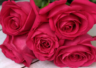 Red pink bouquet of roses on a wooden background