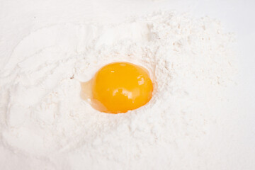 Baking ingredients: flour, eggs, sugar, butter, milk and spices on gray marble background