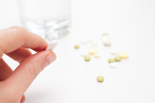 Pill in hand on a white background