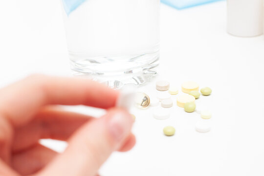 Pill in hand on a white background