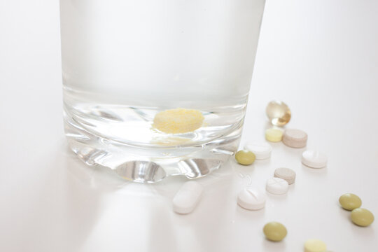 tablet in a glass of water on white table