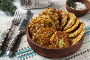 Zucchini fritters on brown plate, horizontal photo, closeup