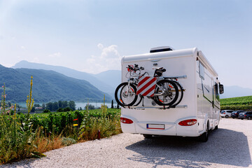 Vacation trip with RV caravan Car with bicycle at Italian South Tirol - obrazy, fototapety, plakaty