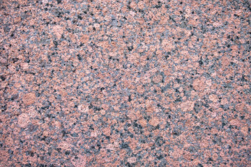 red granite stone with black and light dots. rough surface texture