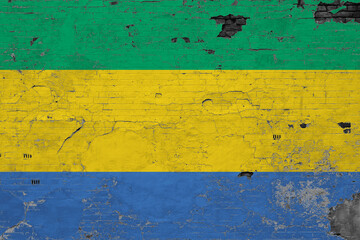 Gabon flag on grunge scratched concrete surface. National vintage background. Retro wall concept.