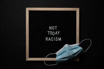 Black Lives Matter Protest Sign on a black background with covid fask mask