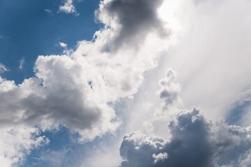 White and gray fluffy clouds in the blue sky. Beautiful sky background