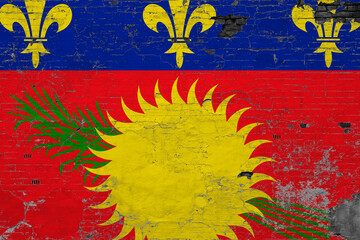 Guadeloupe flag on grunge scratched concrete surface. National vintage background. Retro wall concept.