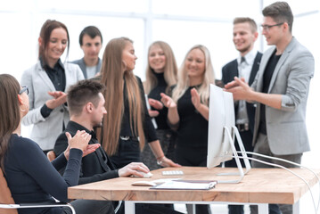 happy working group applauding in the workplace