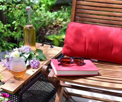 Outdoor patio seating in beautiful tranquil backyard sanctuary with beautiful landscaping for mindful relaxation on a warm summer afternoon during quarantine stay at home vacation