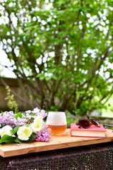 Outdoor relaxing patio in beautiful serene landscaped garden for sitting on a warm summer day with a glass of wine and book during a stay at home vacation during quarantine lockdown