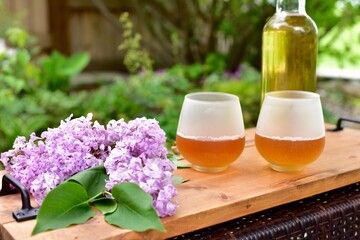 Outdoor relaxing patio in beautiful serene landscaped garden for sitting on a warm summer day with a glass of wine and book during a stay at home vacation during quarantine lockdown