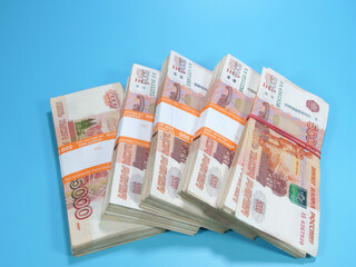 big stack of Russian 5000 rubles banknotes laying on blue background