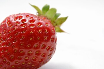 Macro  of the garden strawberry (Fragaria ananassa). Closeup of fresh red and ripe strawberry. Freshly harvested strawberry  texture. Selective focus.